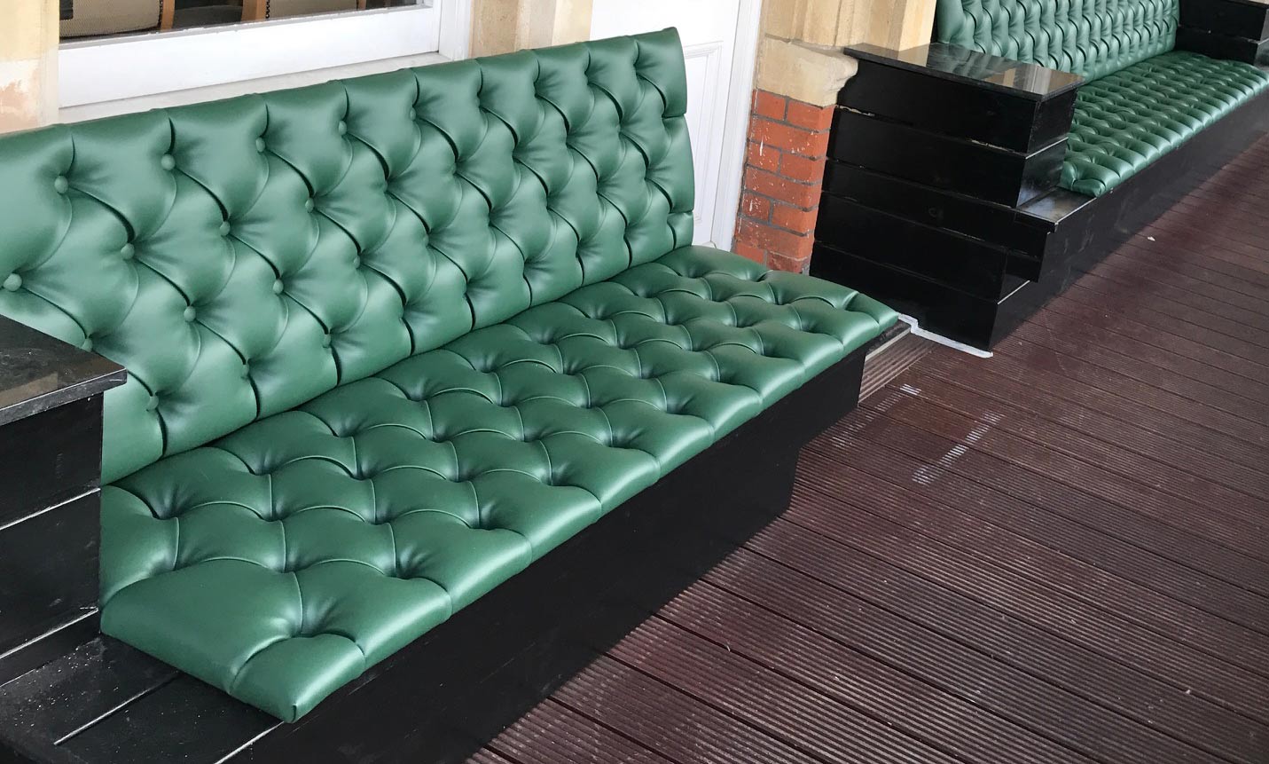 Pub seat upholstered with green leather
